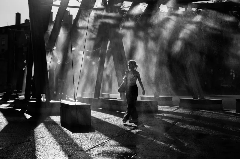Shafts of light crossing a hall, black and white