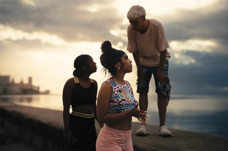 People strolling along the seafront at sunset